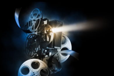 Cinema,Background,With,Movie,Projector,And,Film,Reels,On,A